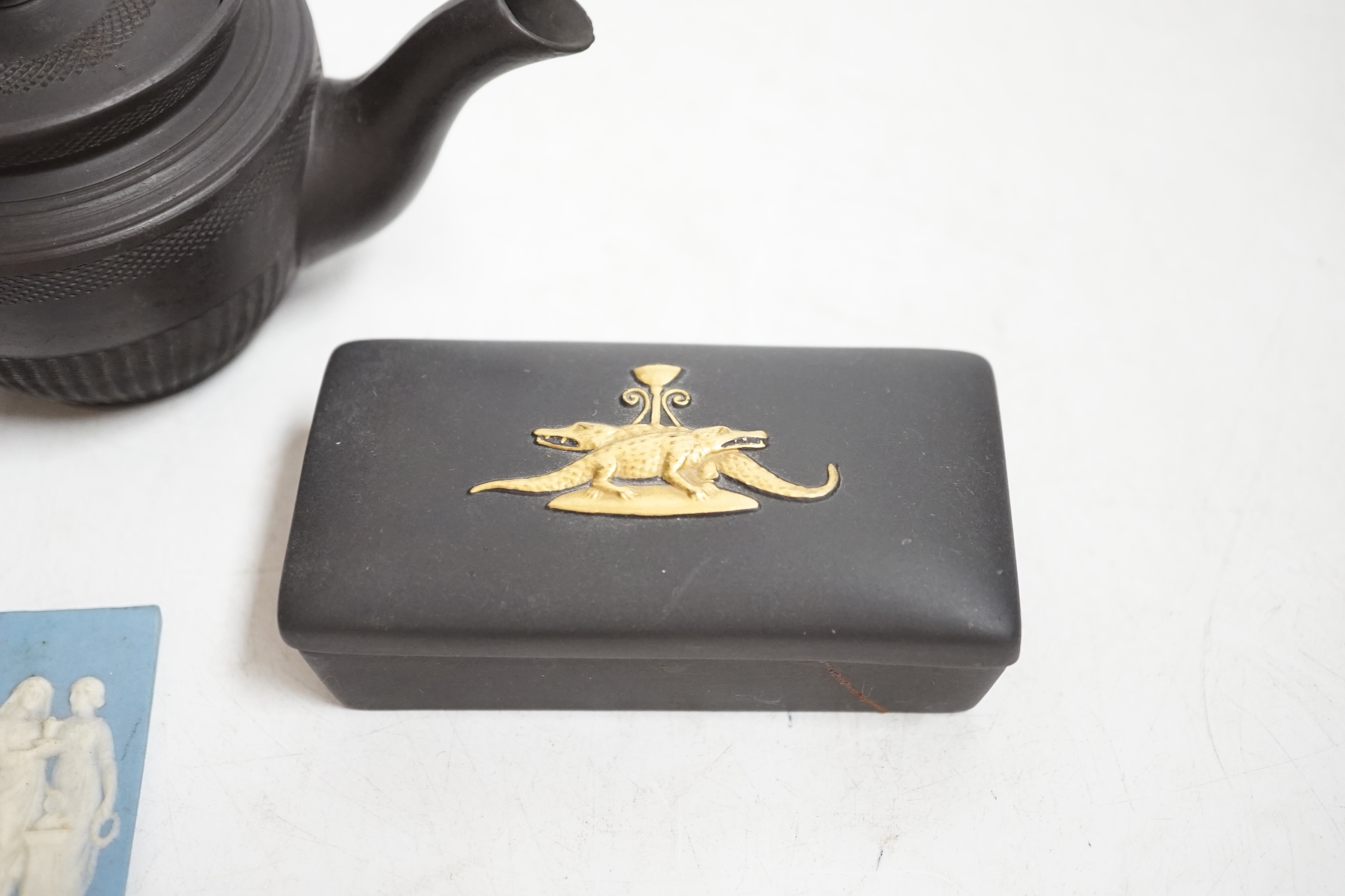 Wedgwood pieces comprising two plaques including a jasperware example and two small boxes, together with a black basalt teapot, largest 14cm wide. Condition - poor to fair